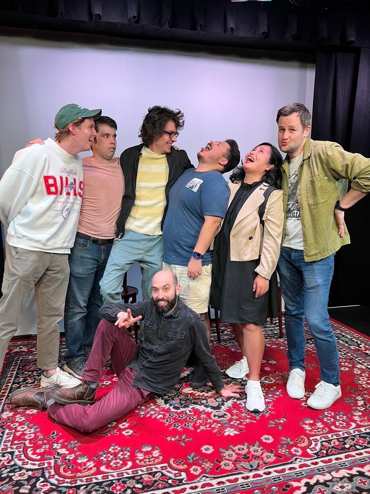 Seven improvisers posing goofy on stage