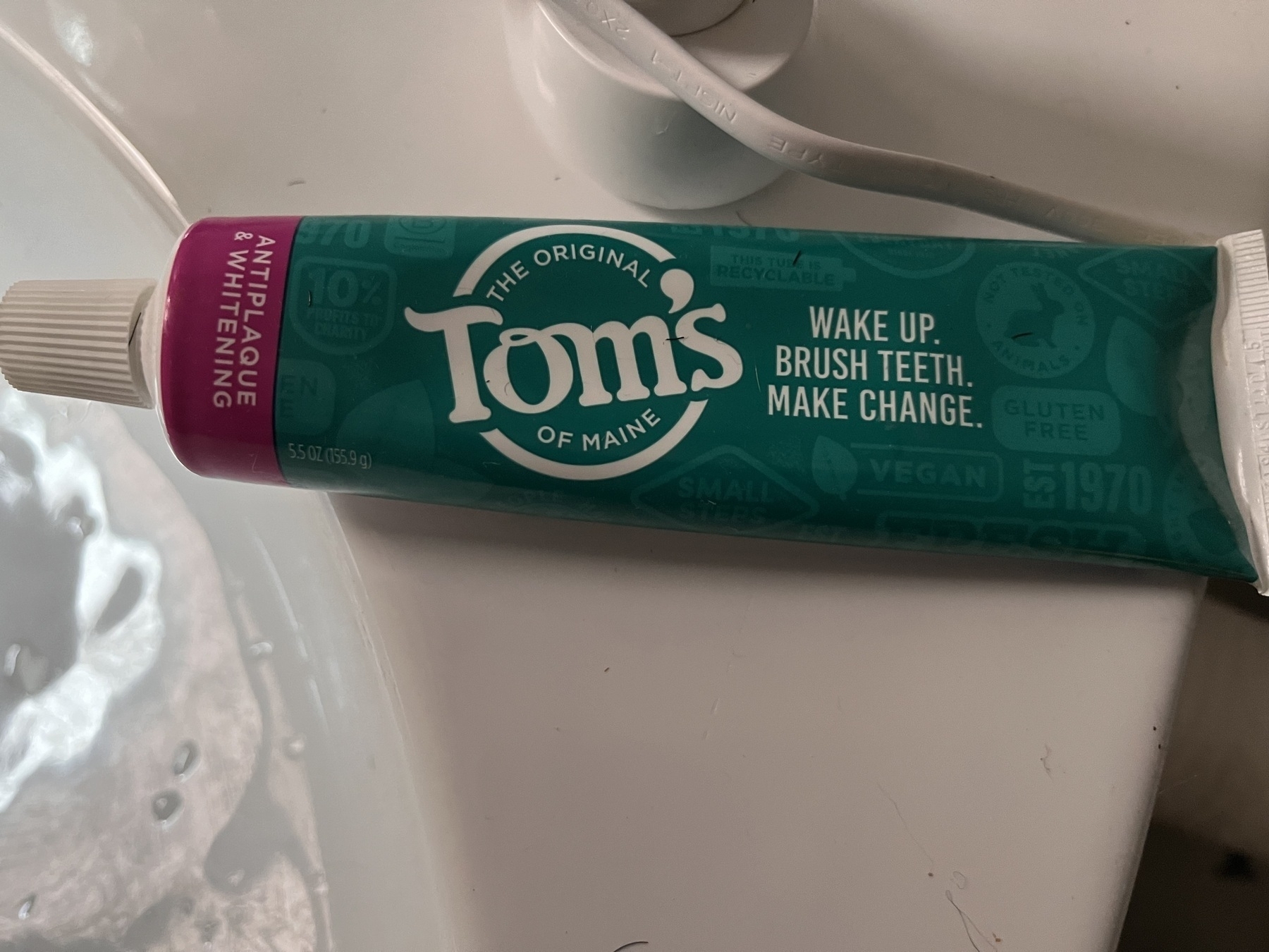 Toms of main brand toothpaste. Their printed motto is “wake up. Brush teeth. Make change. “