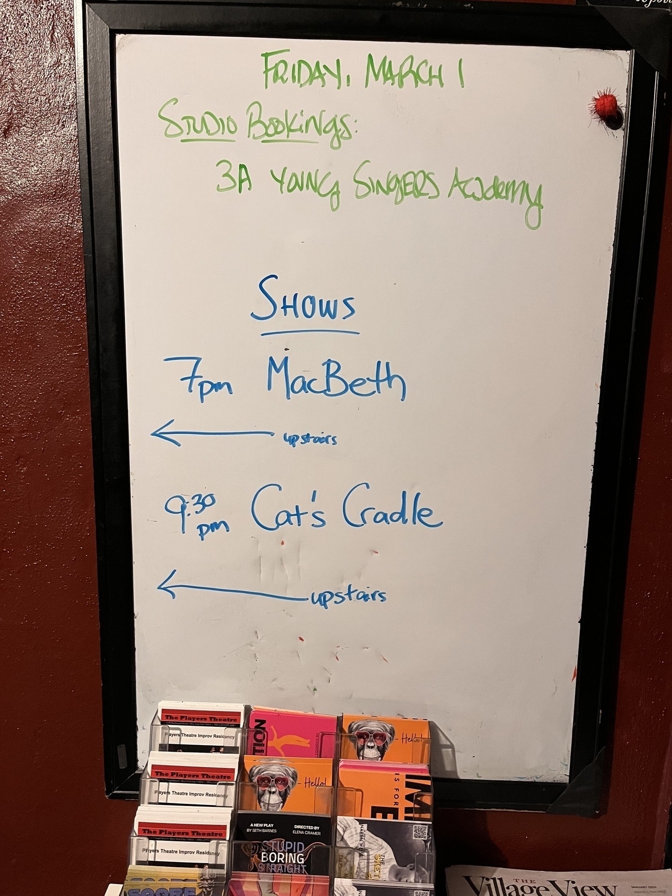 A white board with Macbeth at 7pm and Cats Cradle at 9pm. 
