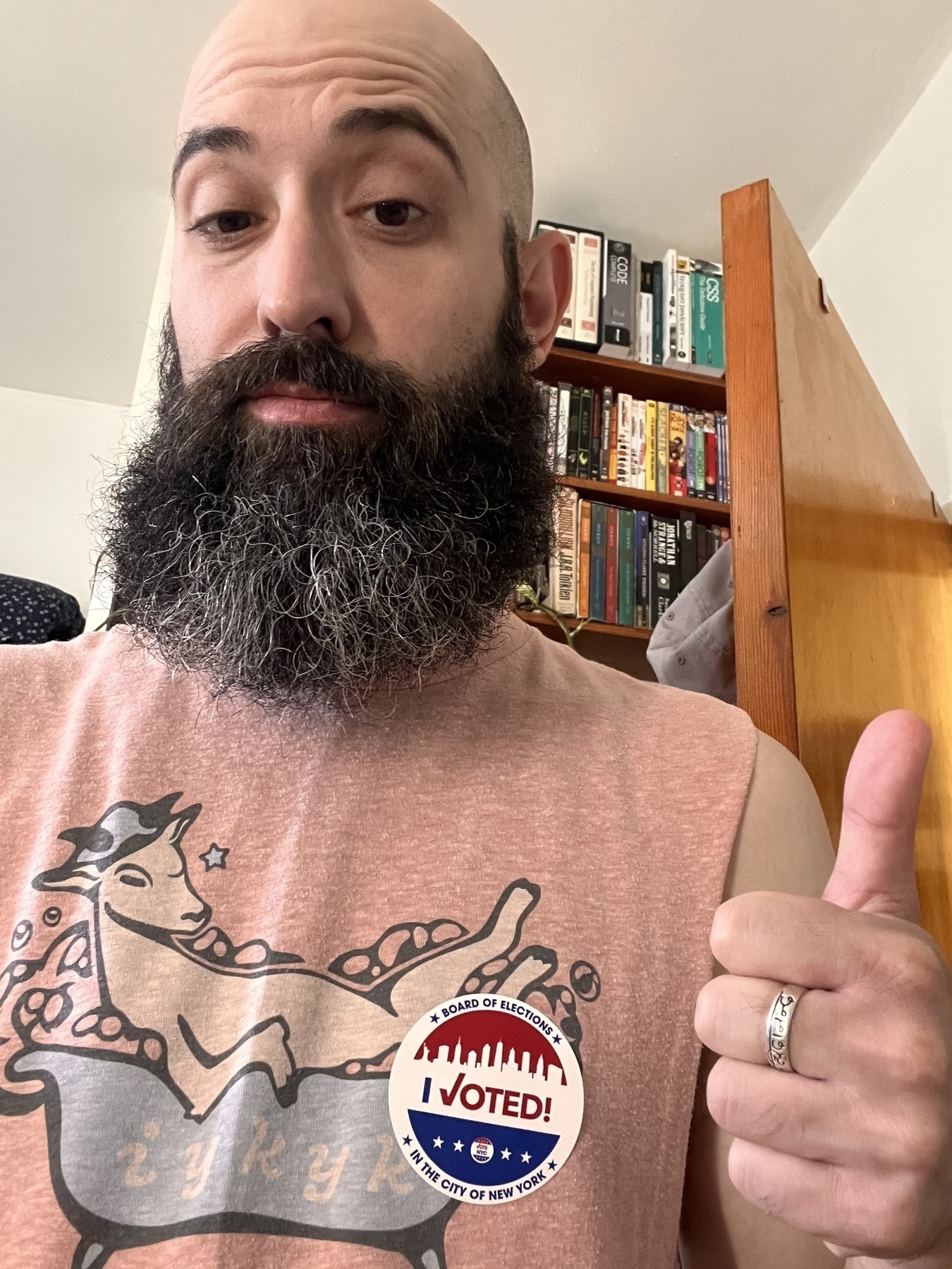 Me, a bald white dude with a big beard, posing with my I voted sticker on my shirt. I’m giving a thumbs up.
